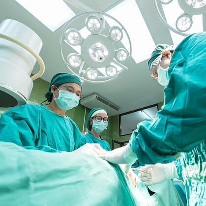 Three doctors conducting an operation.
