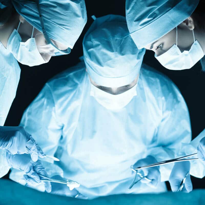 Three surgeons operating.
