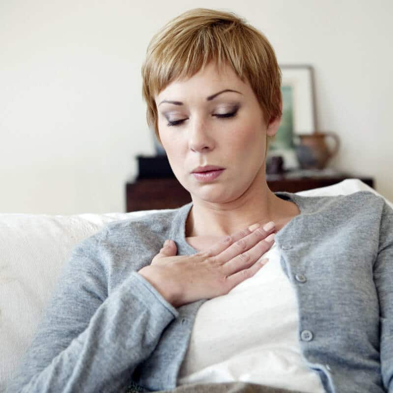 A woman is having troubles breathing.