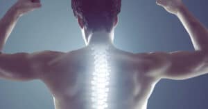 A man is flexing his muscles