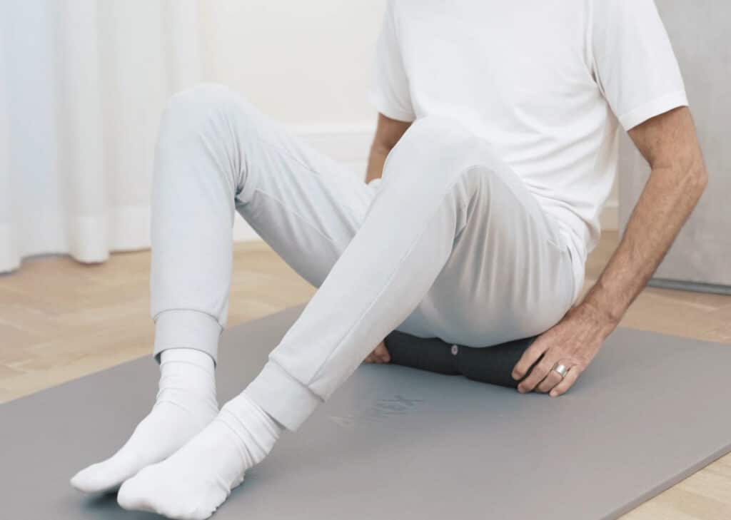Roland is sitting on a midi foam roller.