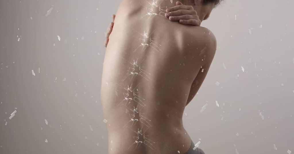 Closeup of a woman's back, she's leaning to the left.