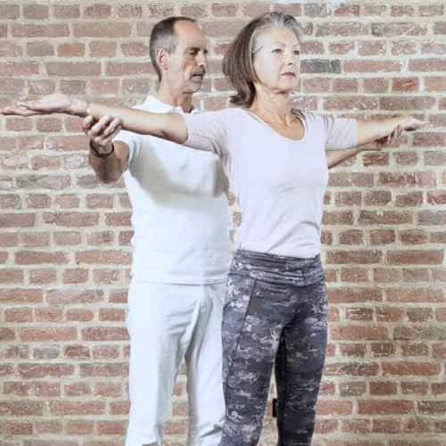 A woman is demonstrating an upper body rotation.