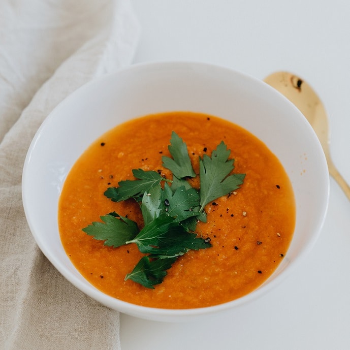 Bowl of soup for osteoarthritis diet; containing carrots, orange - vegan friendly