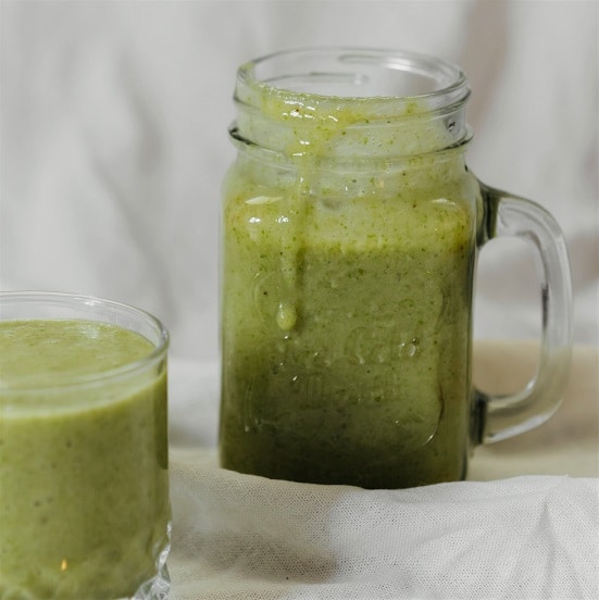 A jar glass filled with nutritious green smoothie; recipe for osteoarthritis