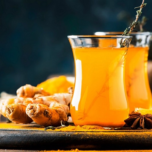 image of healthy vegan tea recipe containing turmeric, ginger, honey and lemon