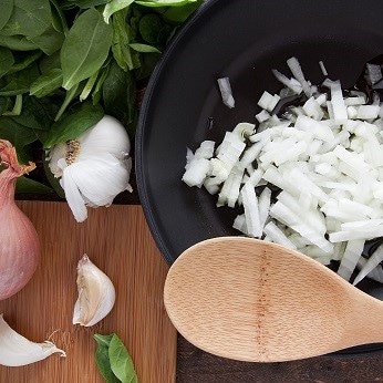 Image of chopped onion in a frying pan before frying