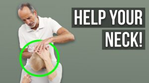 Roland Liebscher-Bracht supports a woman doing a neck pain exercise.