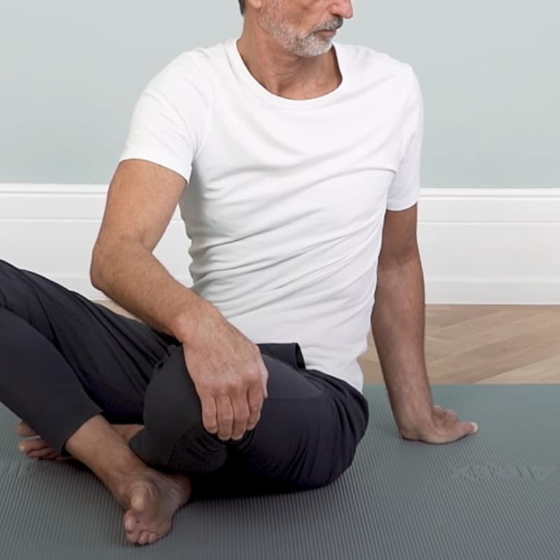 Roland demonstrates full body stretch exercise 3.