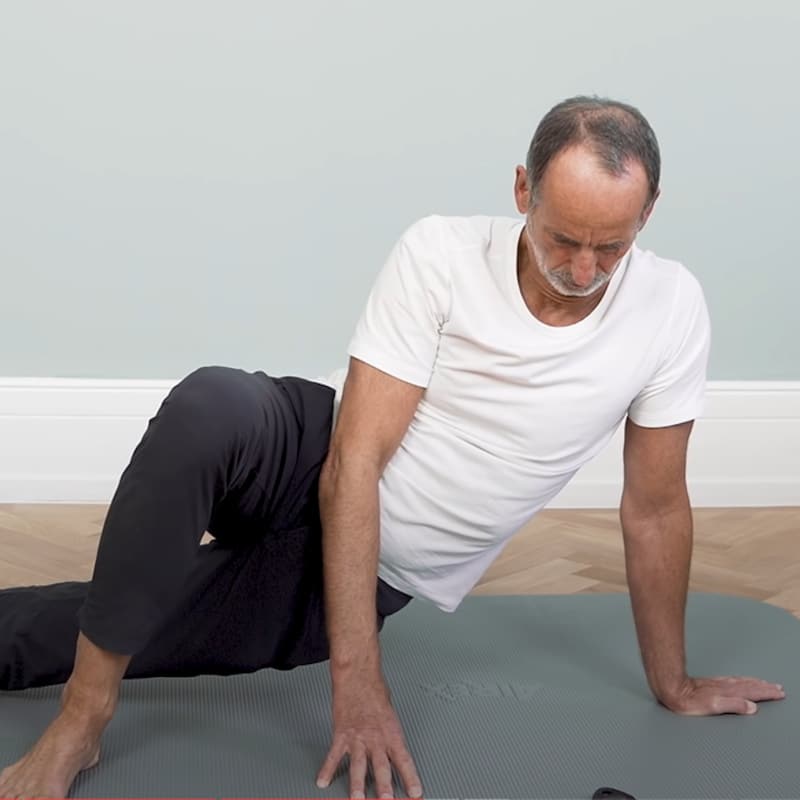 Roland demonstrates full body stretch exercise 4.
