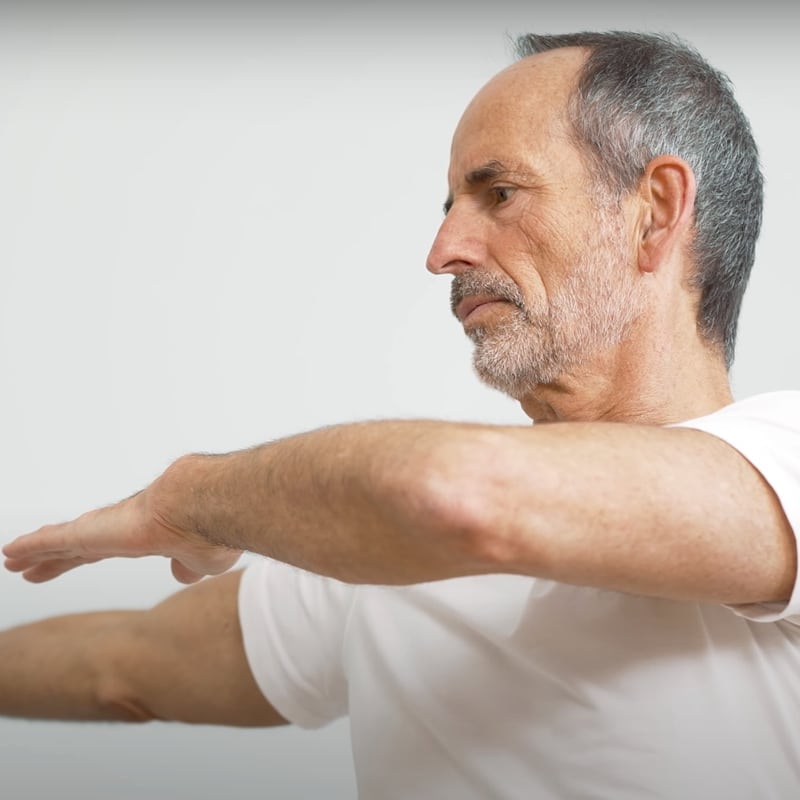 Roland demonstrates full body stretch exercise 5.