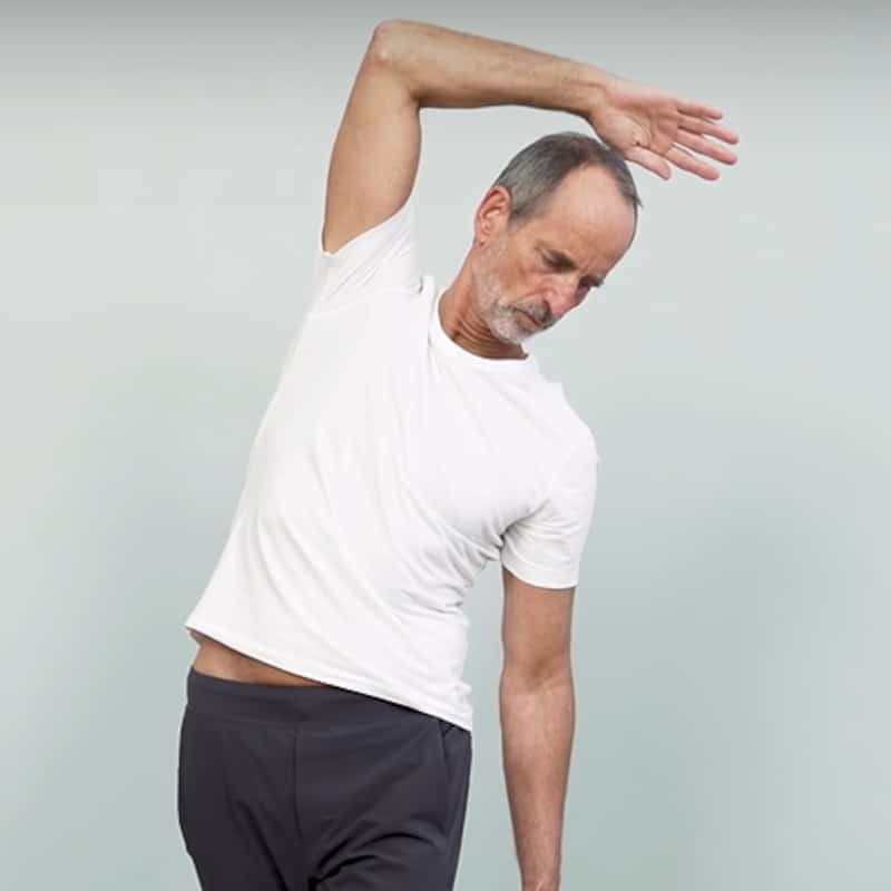 Roland demonstrates full body stretch exercise 5.