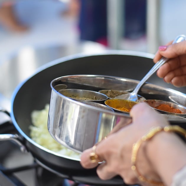 image of spices being added to pot