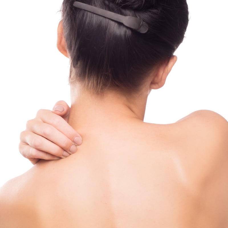 A woman massages her neck pain.