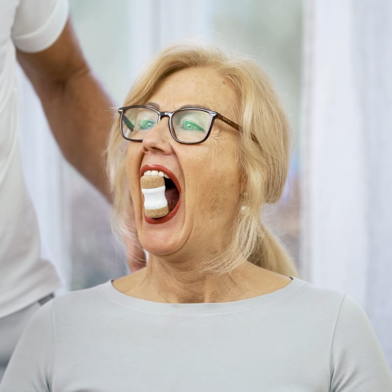 A woman is biting into the Jaw Hero.