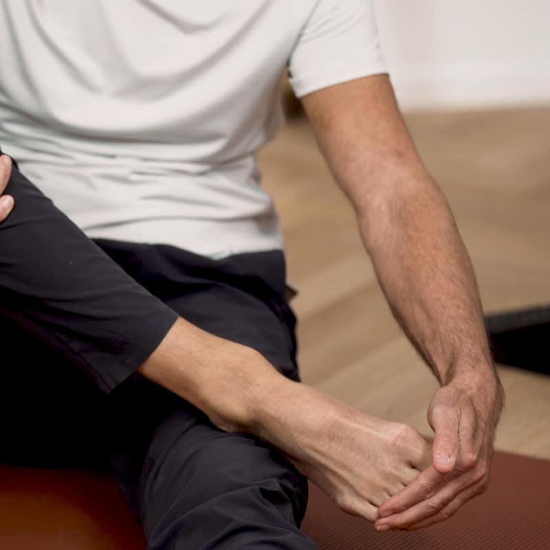 Roland Liebscher-Bracht is bending the toes of his right foot.