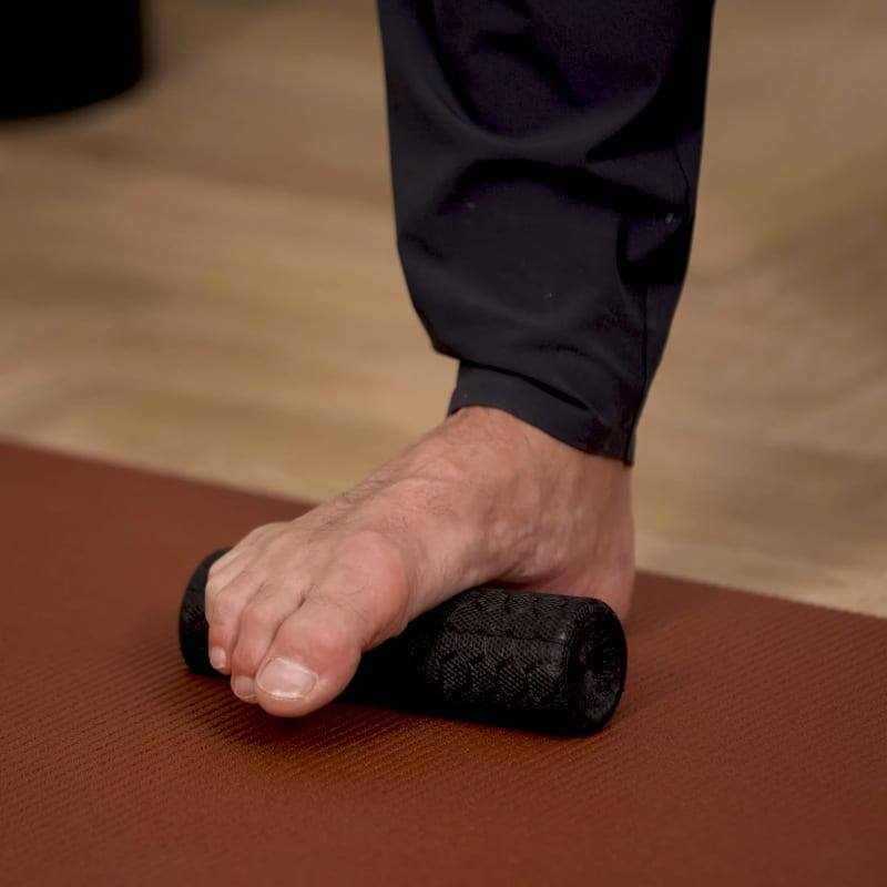 Roland Liebscher-Bracht is standing on the Mini Foam Roller.