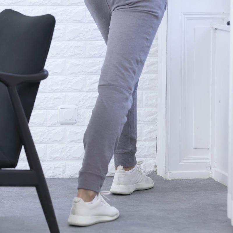 Roland Liebscher-Bracht is stepping forward with his left foot into the corner of a room.