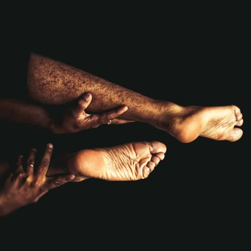 Closeup of the soles of two bare feet.