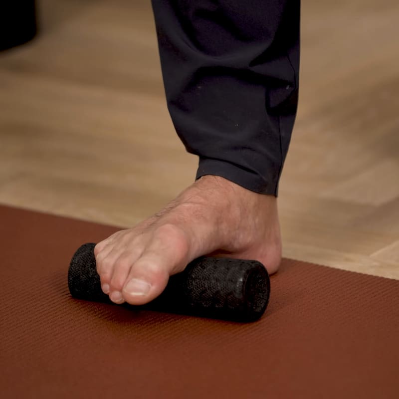 Closeup of a foot on the Mini Foam Roller.