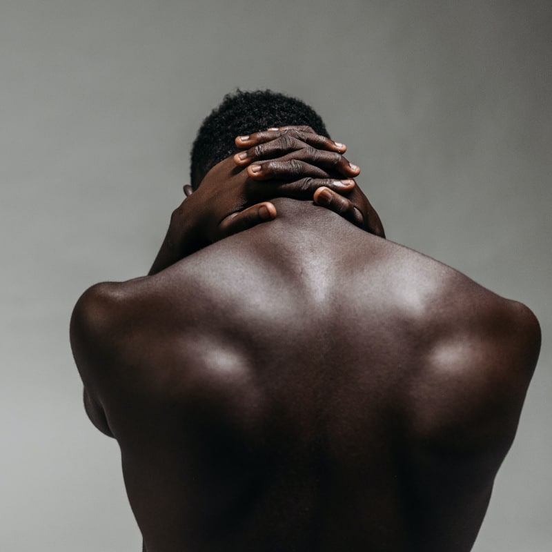Closeup of a man's upper back.
