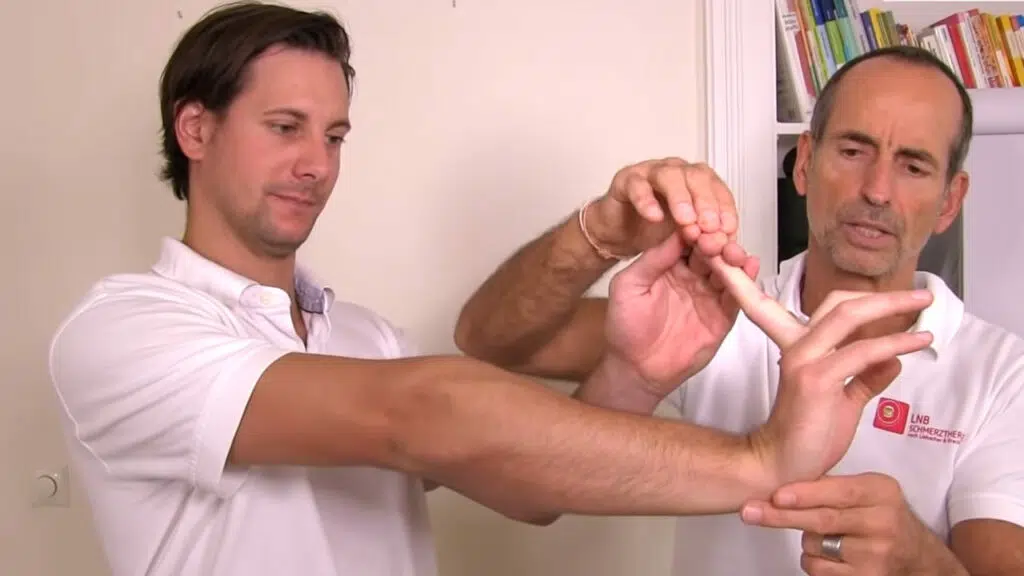Schmerzspezialist Roland Liebscher-Bracht zeigt die Gegenbewegung, um einen Schnappfinger zu behandeln.